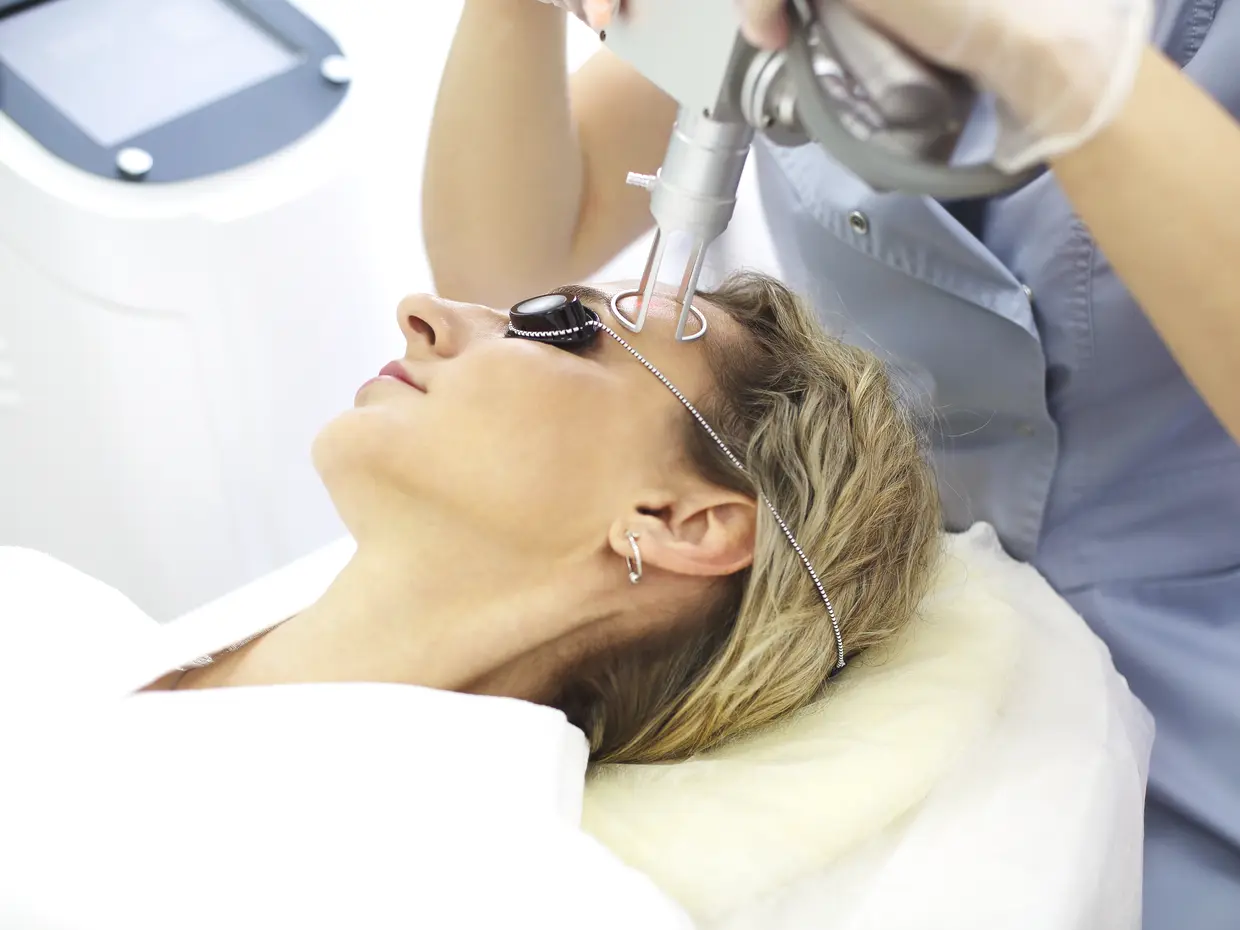 woman receiving laser treatment on forehead