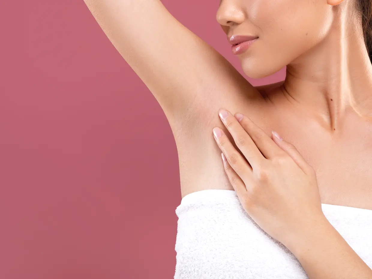 woman's armpit and shoulder with hand